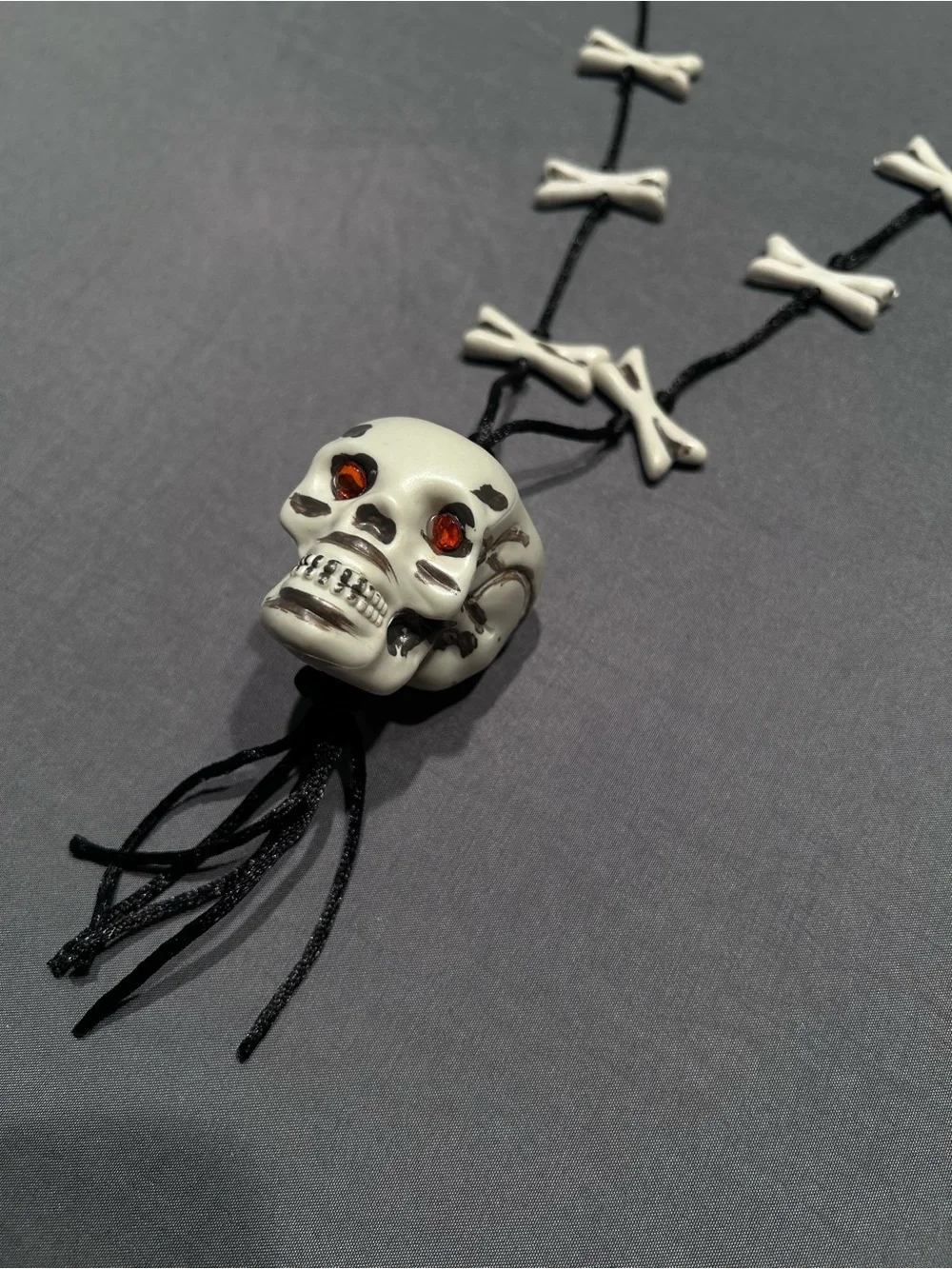 Greenbrier International Plastic Skull and Crossbones Cord Necklace